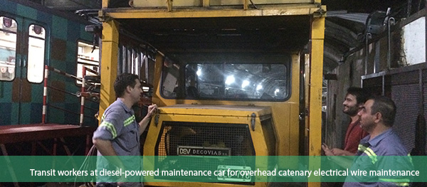 Transit workers at diesel-powered maintenance car for overhead catenary electrical wire maintenance